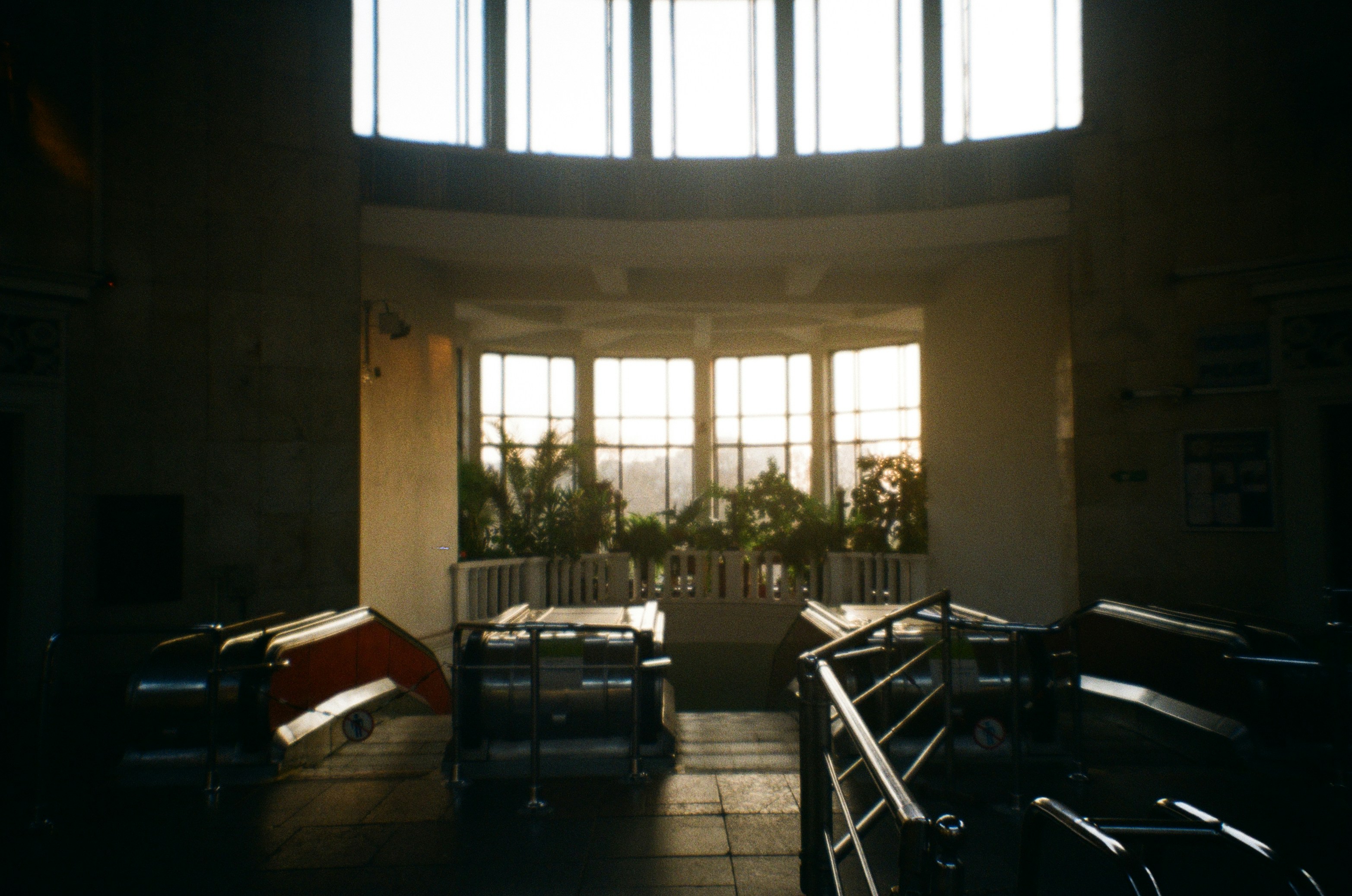 a room filled with lots of windows and lots of luggage