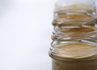 four jars of peanut butter sitting on a table