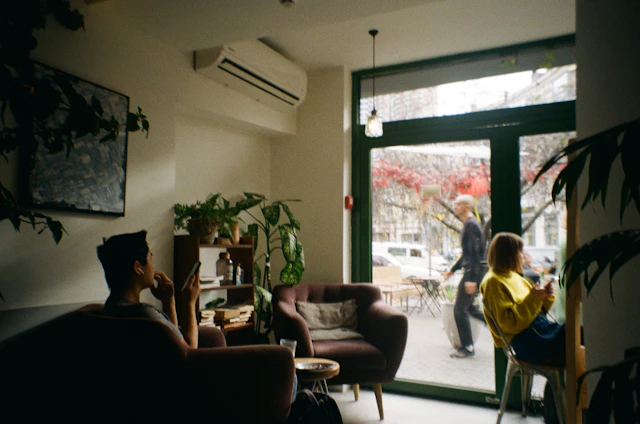 A warm, inviting space with a mentor and mentee sharing a calm conversation over coffee.