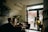 A mobile notary meeting a client at a cozy coffee shop, discussing important documents.