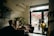 A mobile notary meeting a client at a cozy coffee shop, discussing important documents.