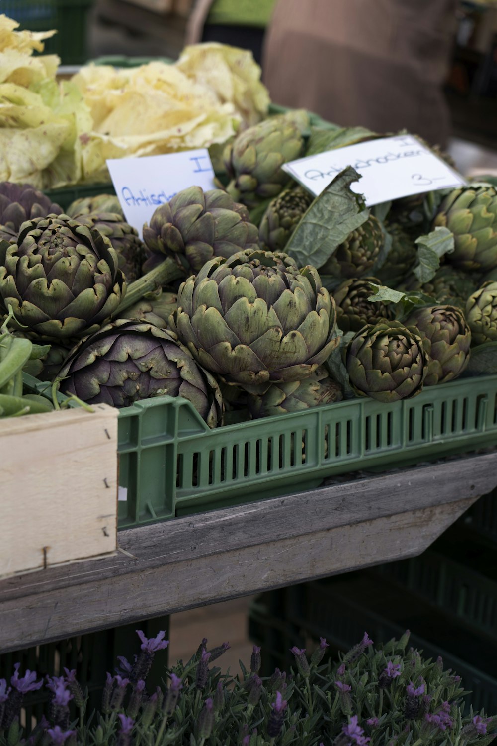 a bunch of artichokes on display in a market