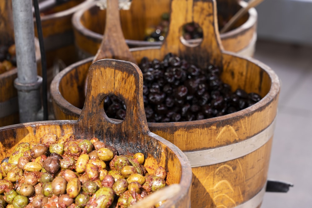 a bunch of wooden buckets filled with grapes