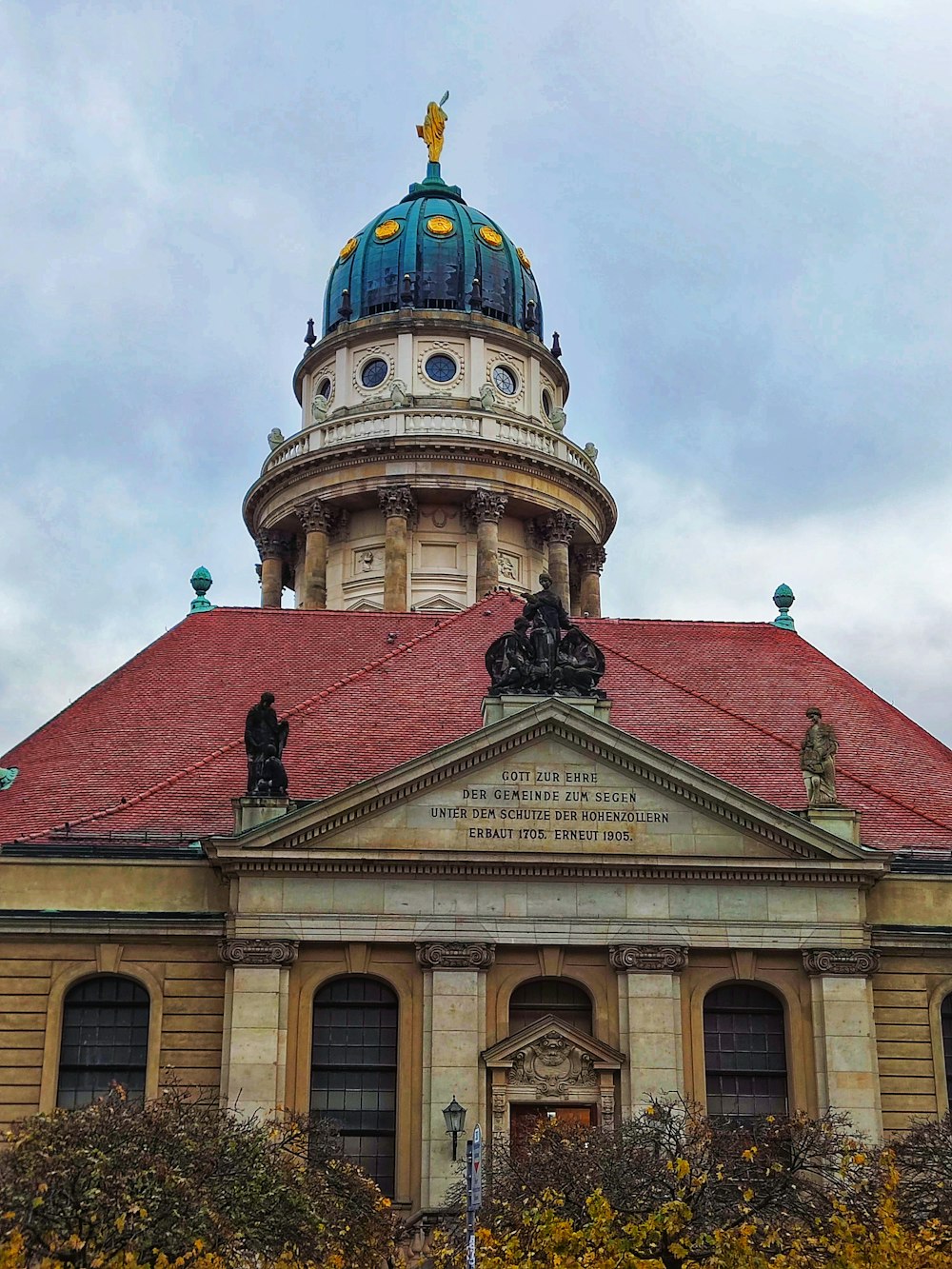 a large building with a red roof and a blue dome