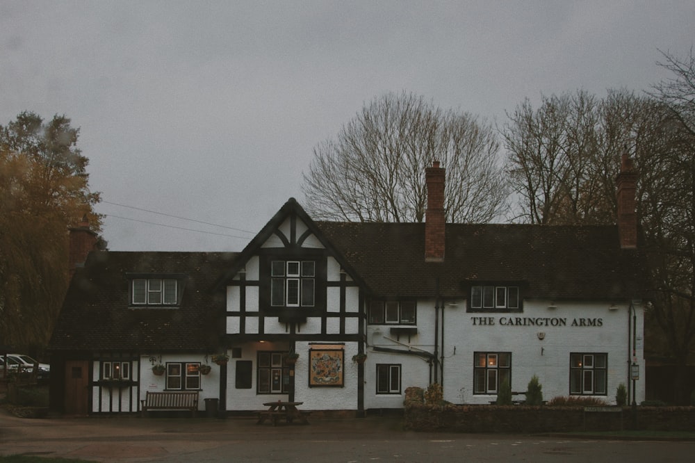 a large white building with a black roof