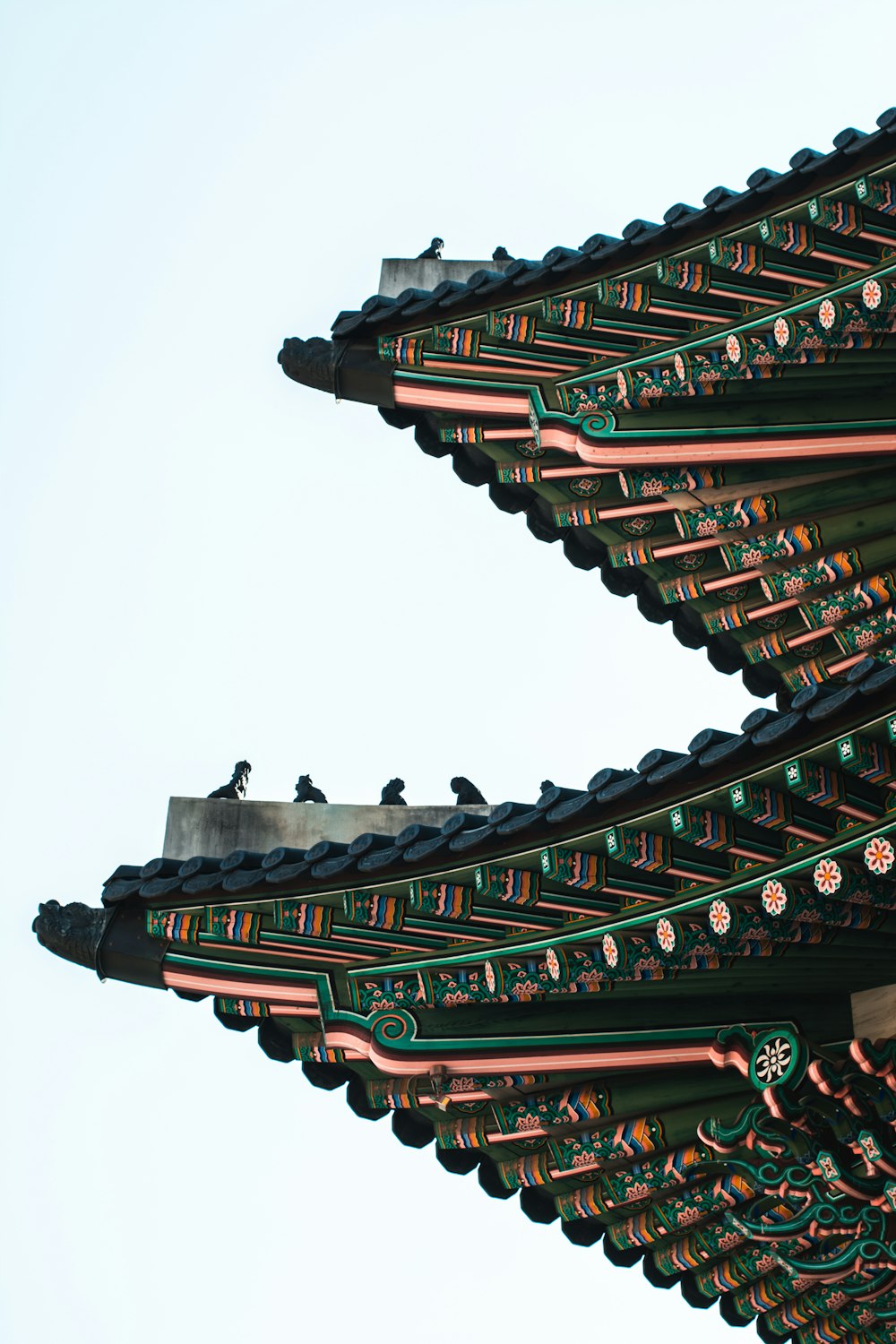 the roof of a building with a bird sitting on top of it