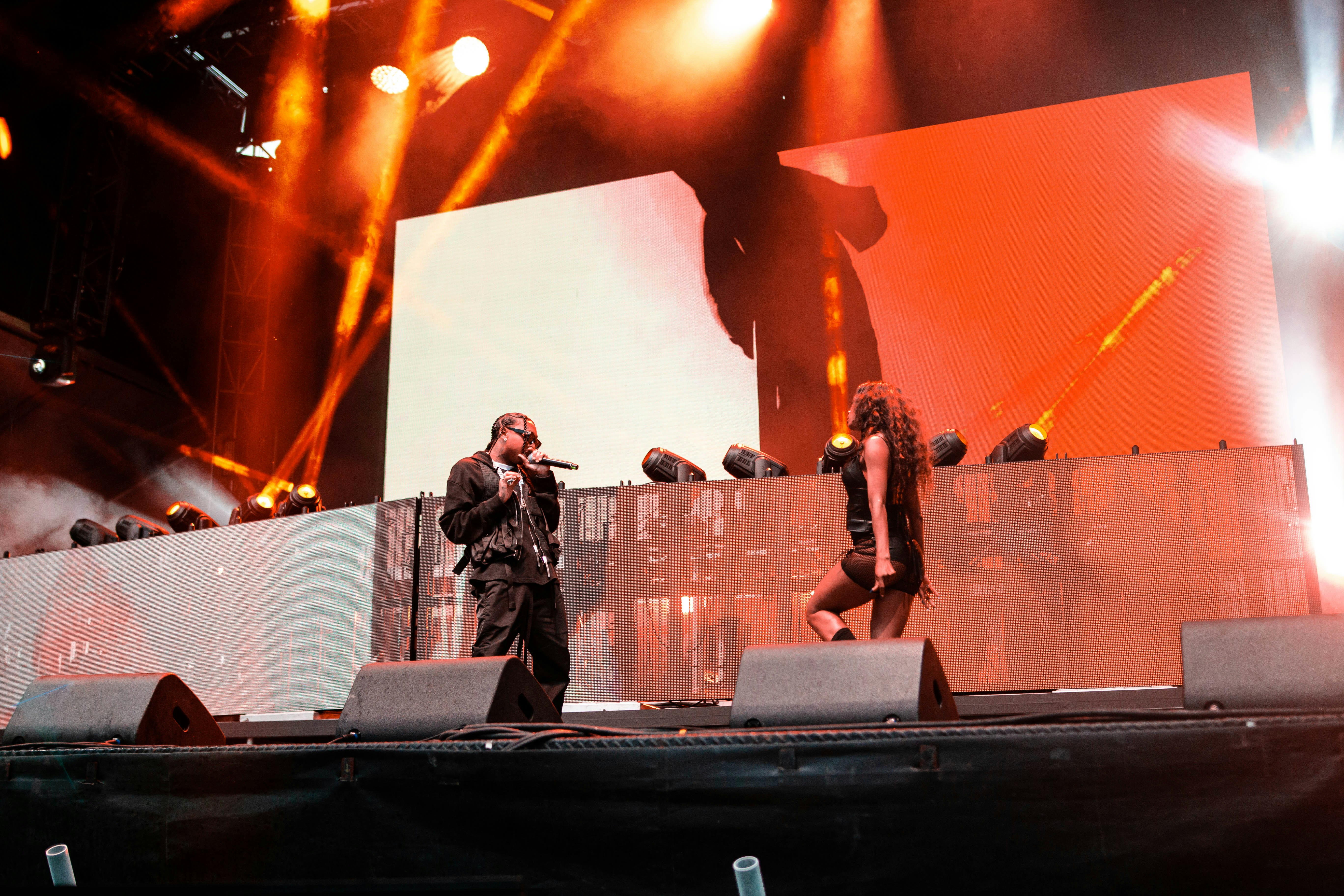 a man standing on top of a stage next to a woman