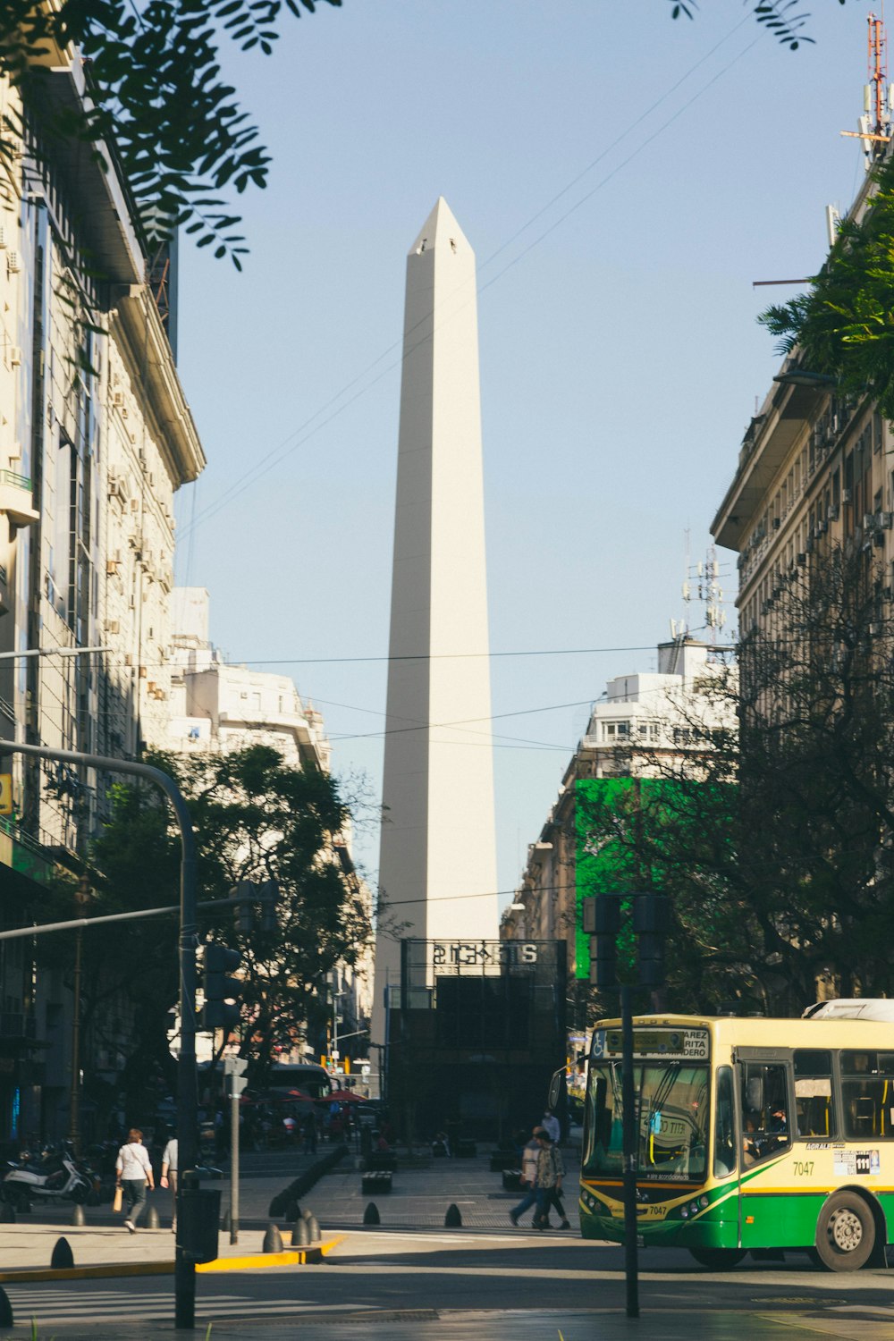 a bus driving down Obelisco de Buenos Aires street