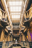 Industrial warehouse interior with large glass windows allowing natural light to flood the space.