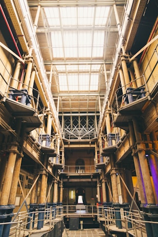 An expansive factory floor with rows of heavy machinery bathed in natural light.