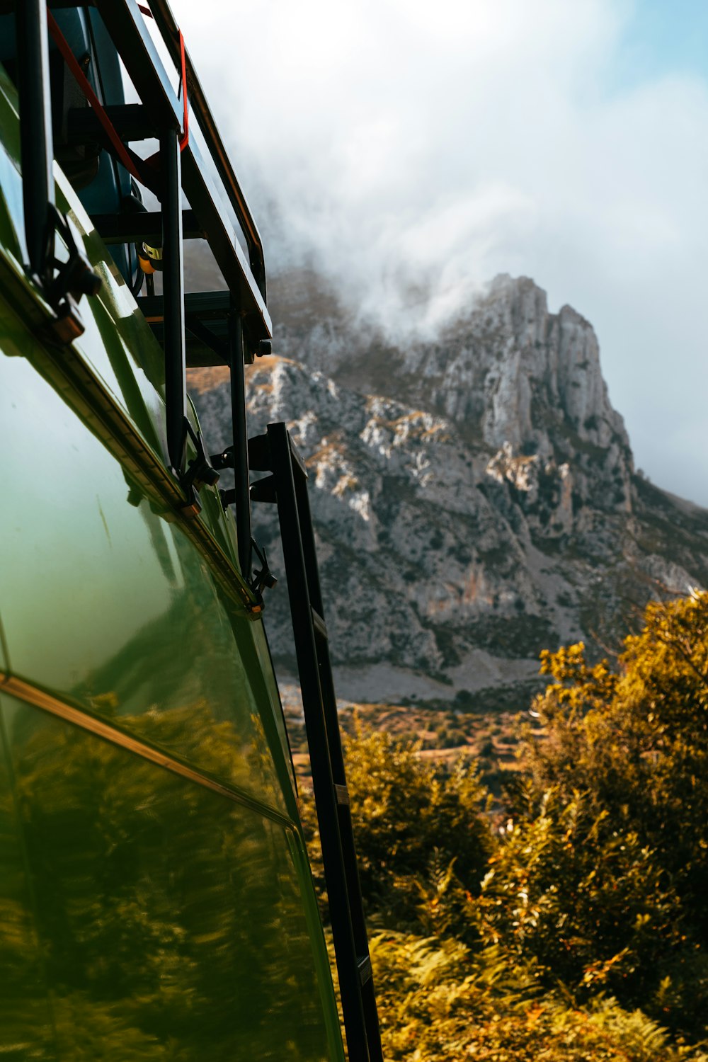 a view of a mountain from behind a bus