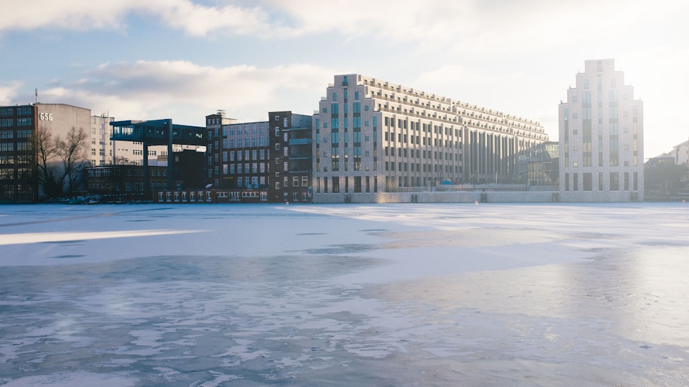 un lac gelé avec des bâtiments en arrière-plan