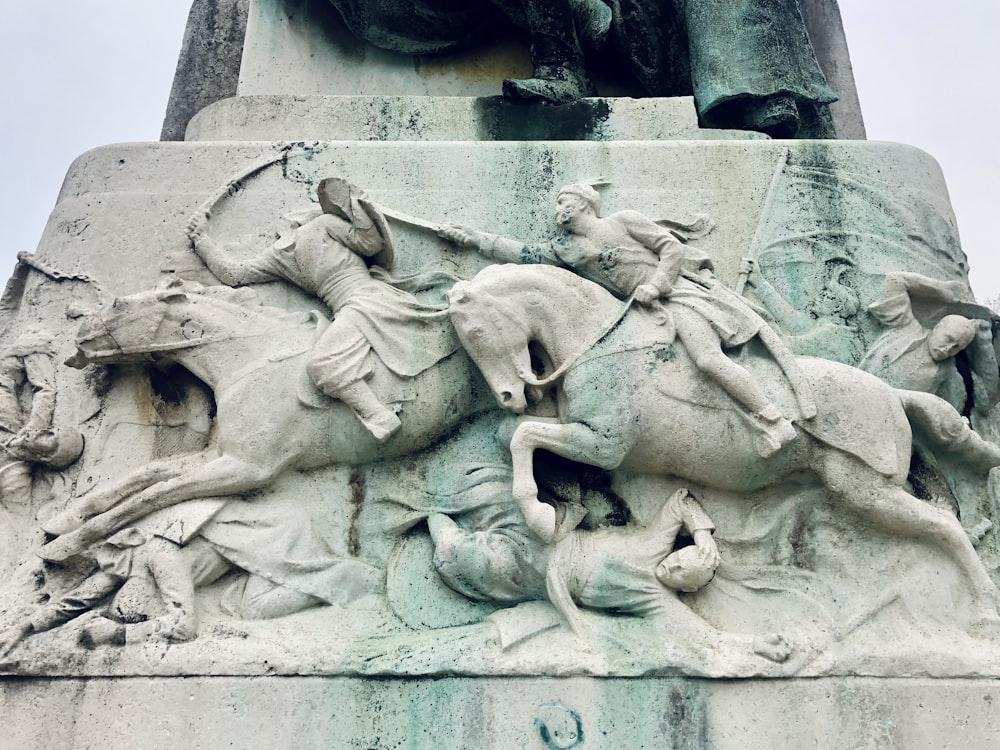 a statue of a man riding a horse next to a statue of a man on
