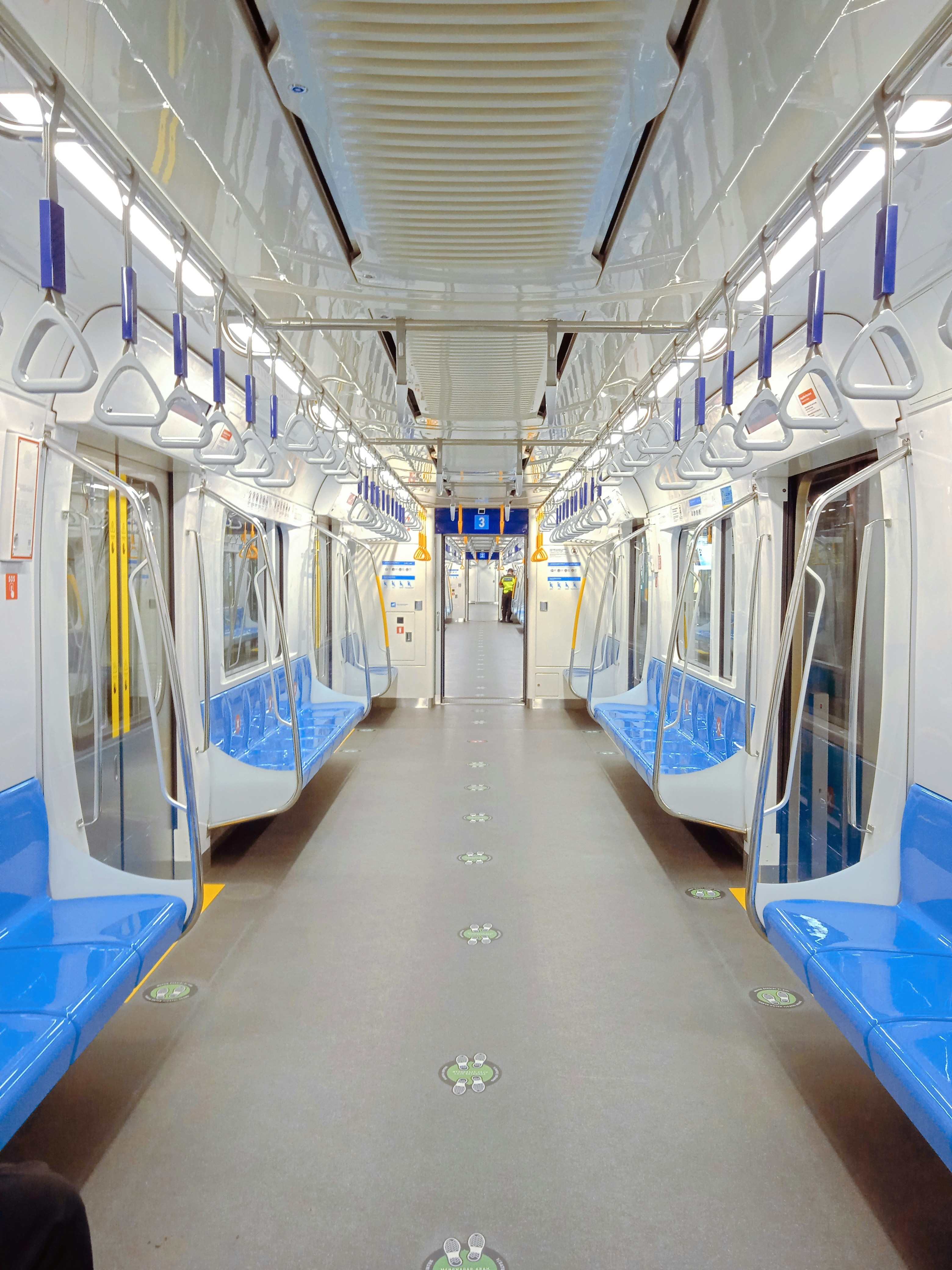 a subway car with blue and white seats