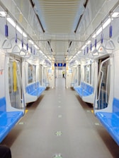 a subway car with blue and white seats