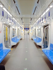 a subway car with blue and white seats
