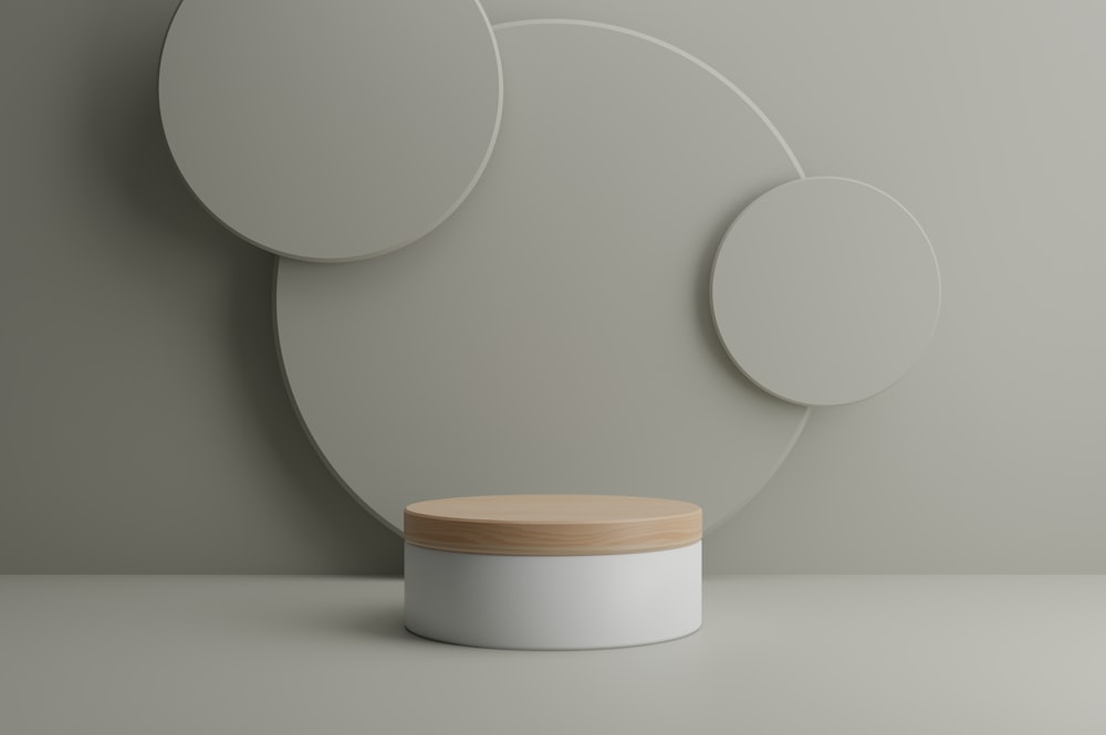 a white container with a wooden lid next to a white wall