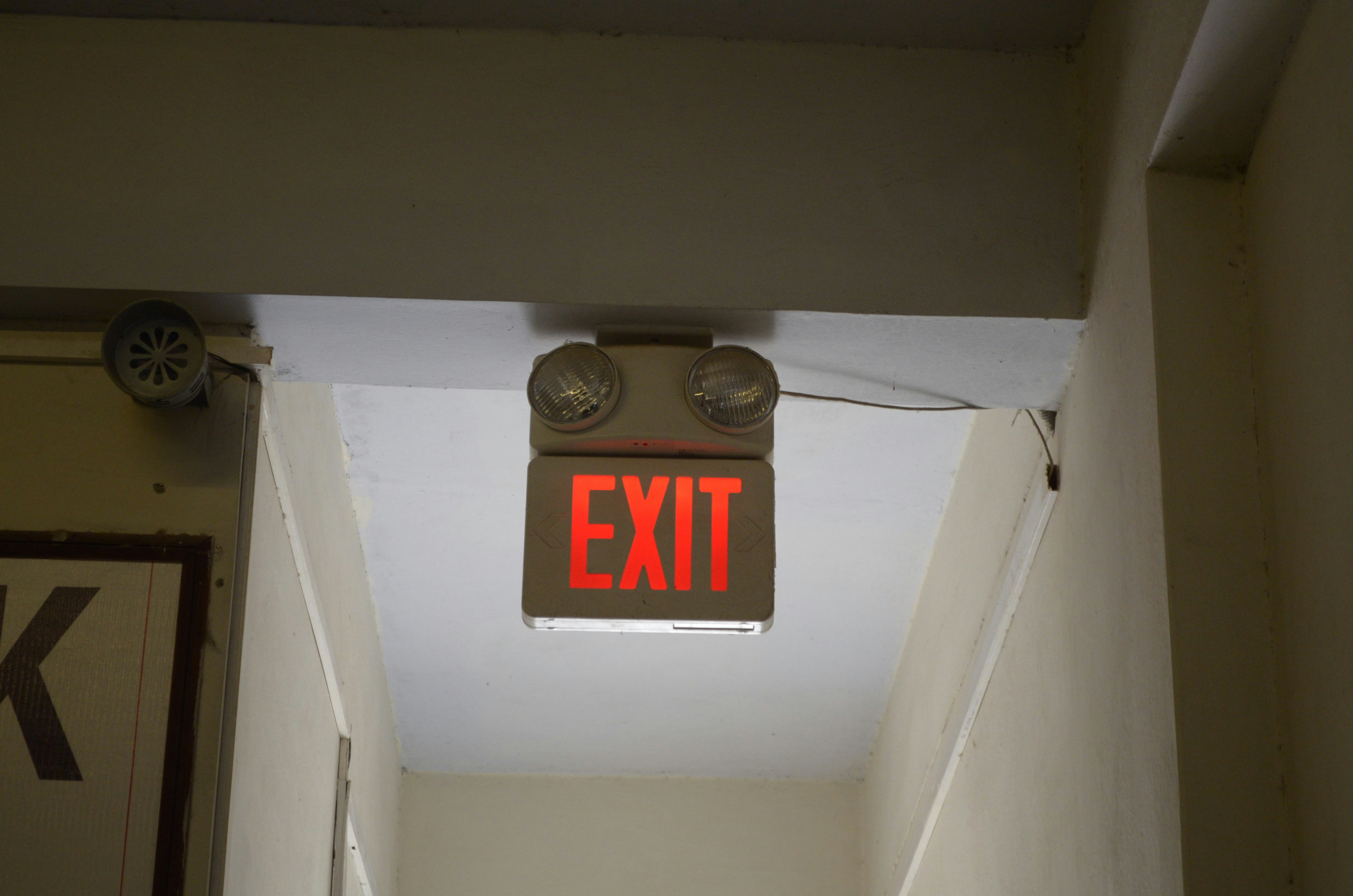 A clearly marked fire escape route in an apartment hallway - multifamily property maintenance