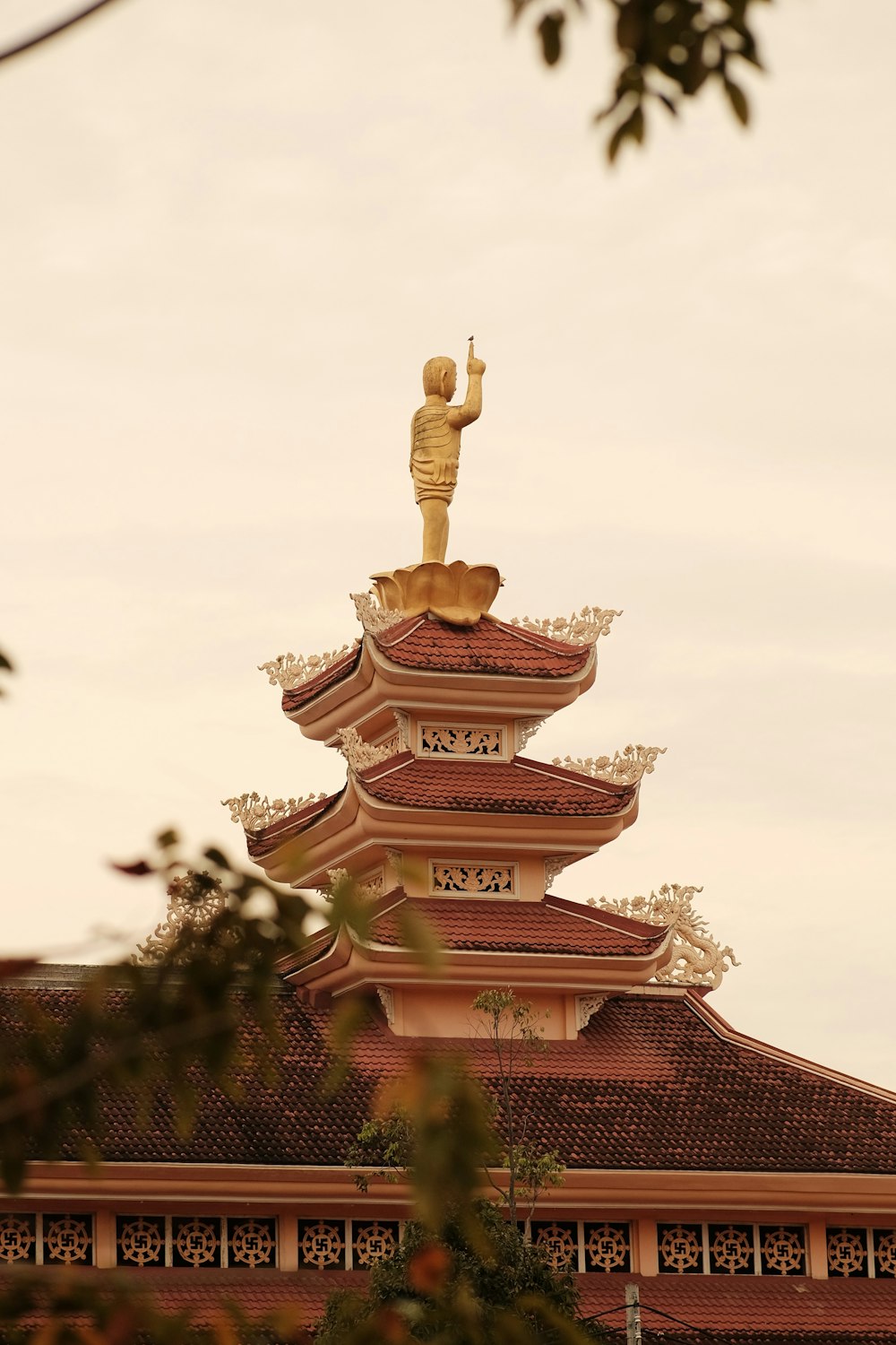 a tall building with a statue on top of it