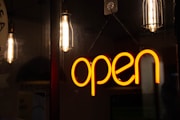 a neon sign hanging from the side of a wall