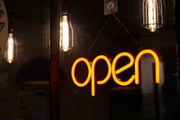 a neon sign hanging from the side of a wall