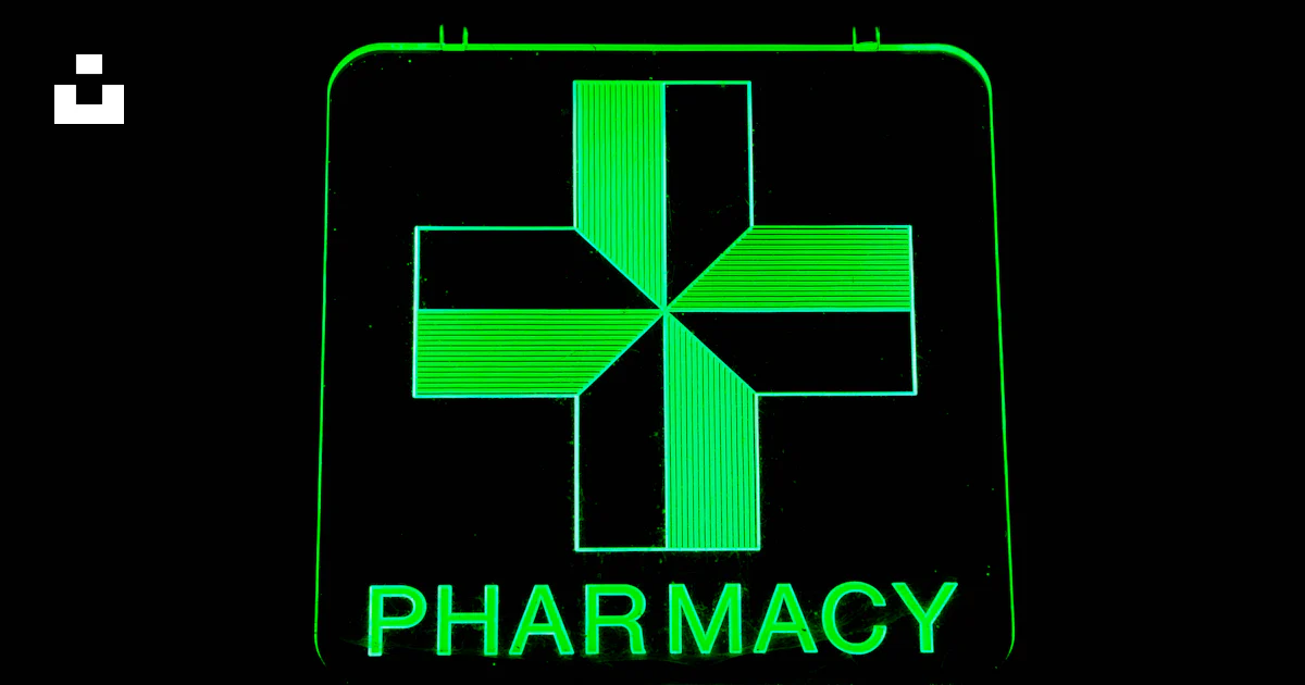 A green pharmacy sign with a cross on it photo – Free Green Image on ...