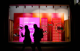 a couple of people that are standing in front of a store