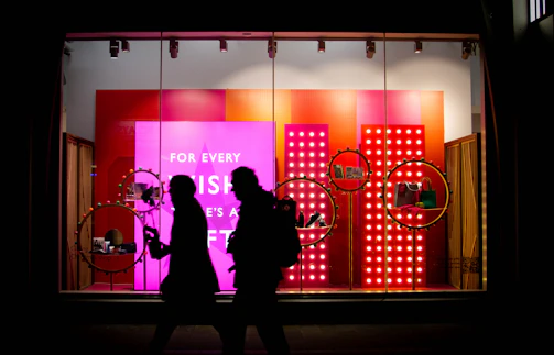 a couple of people that are standing in front of a store