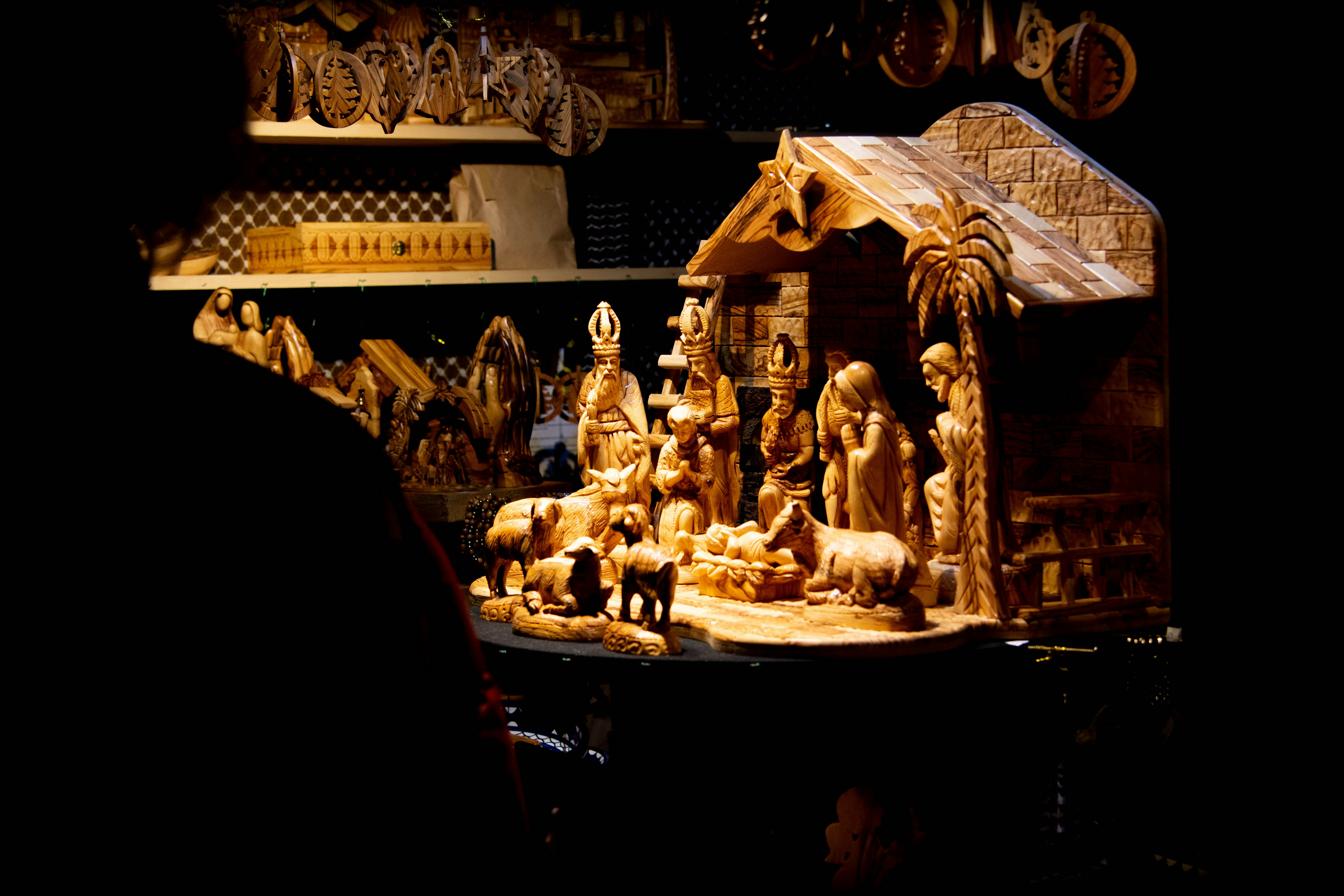 A nativity scene is displayed in a dark room photo Free Nativity