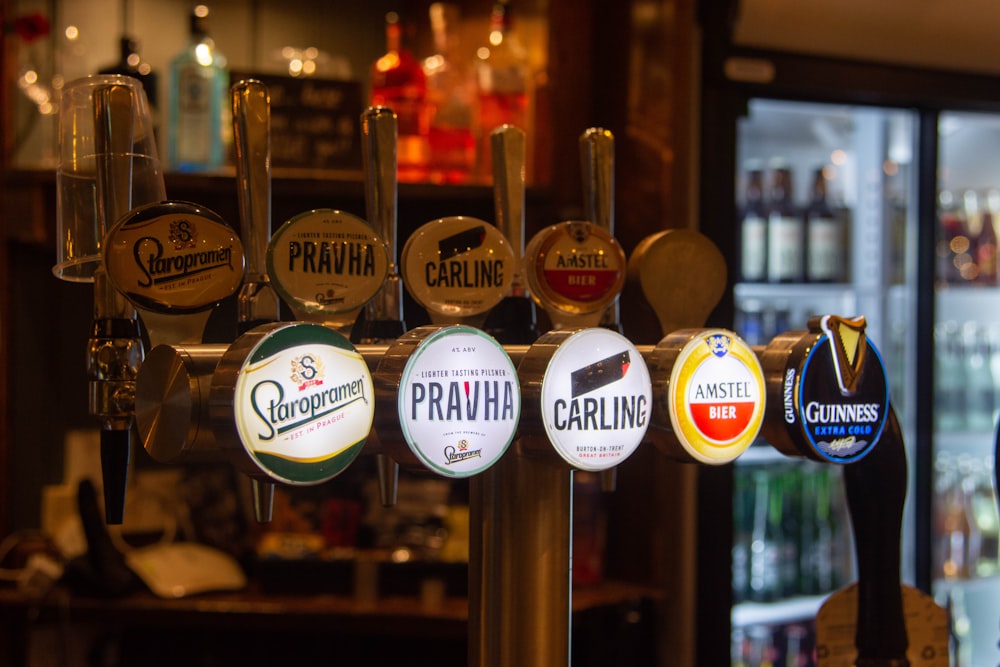 a bunch of different types of beer on a bar