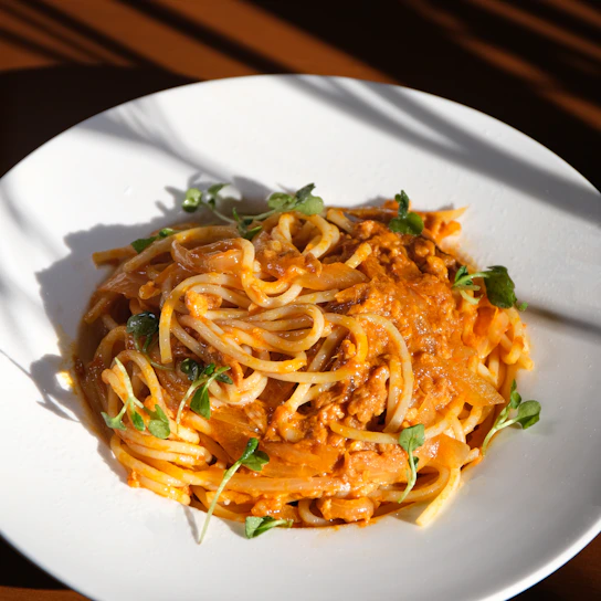 a white plate topped with pasta and sauce