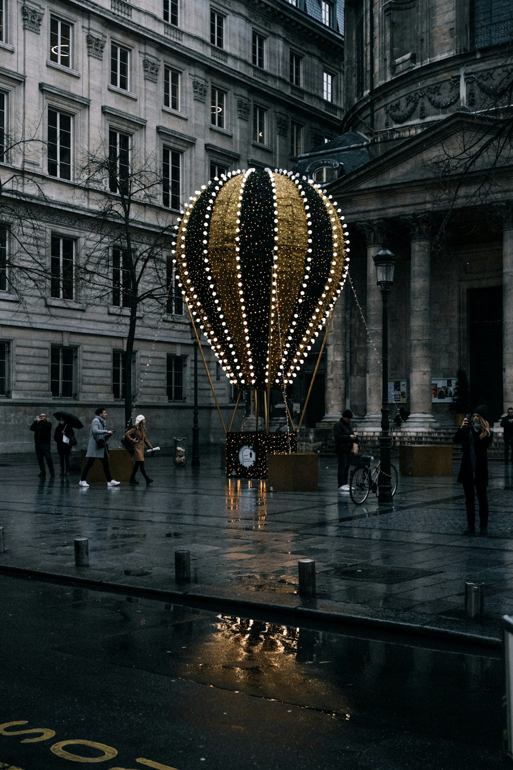 a lighted hot air balloon in the middle of a street