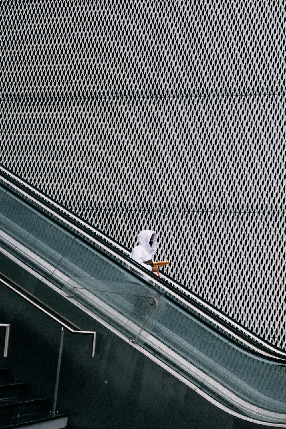 a person riding an escalator on a skateboard