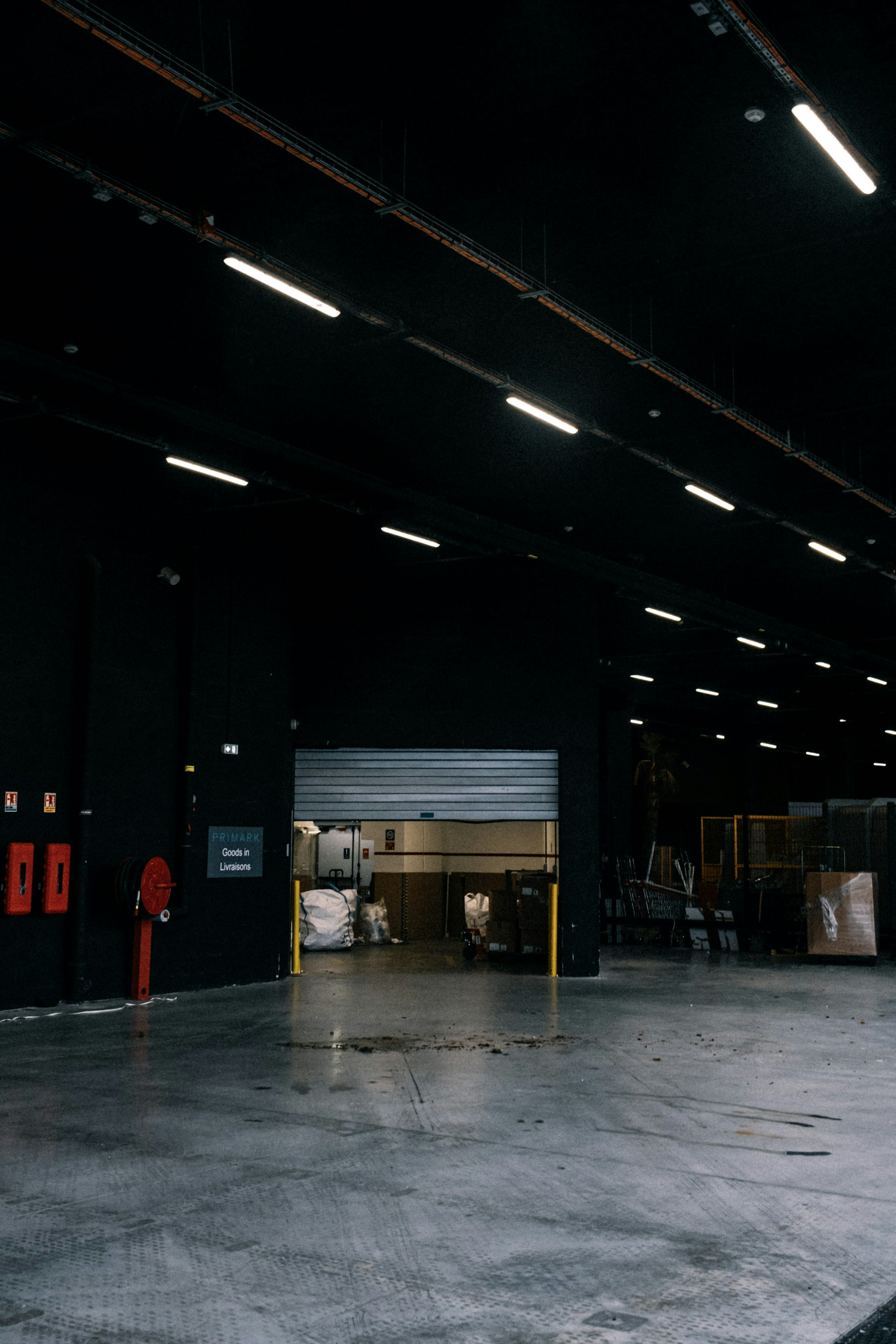 an empty warehouse with a fire hydrant in the middle