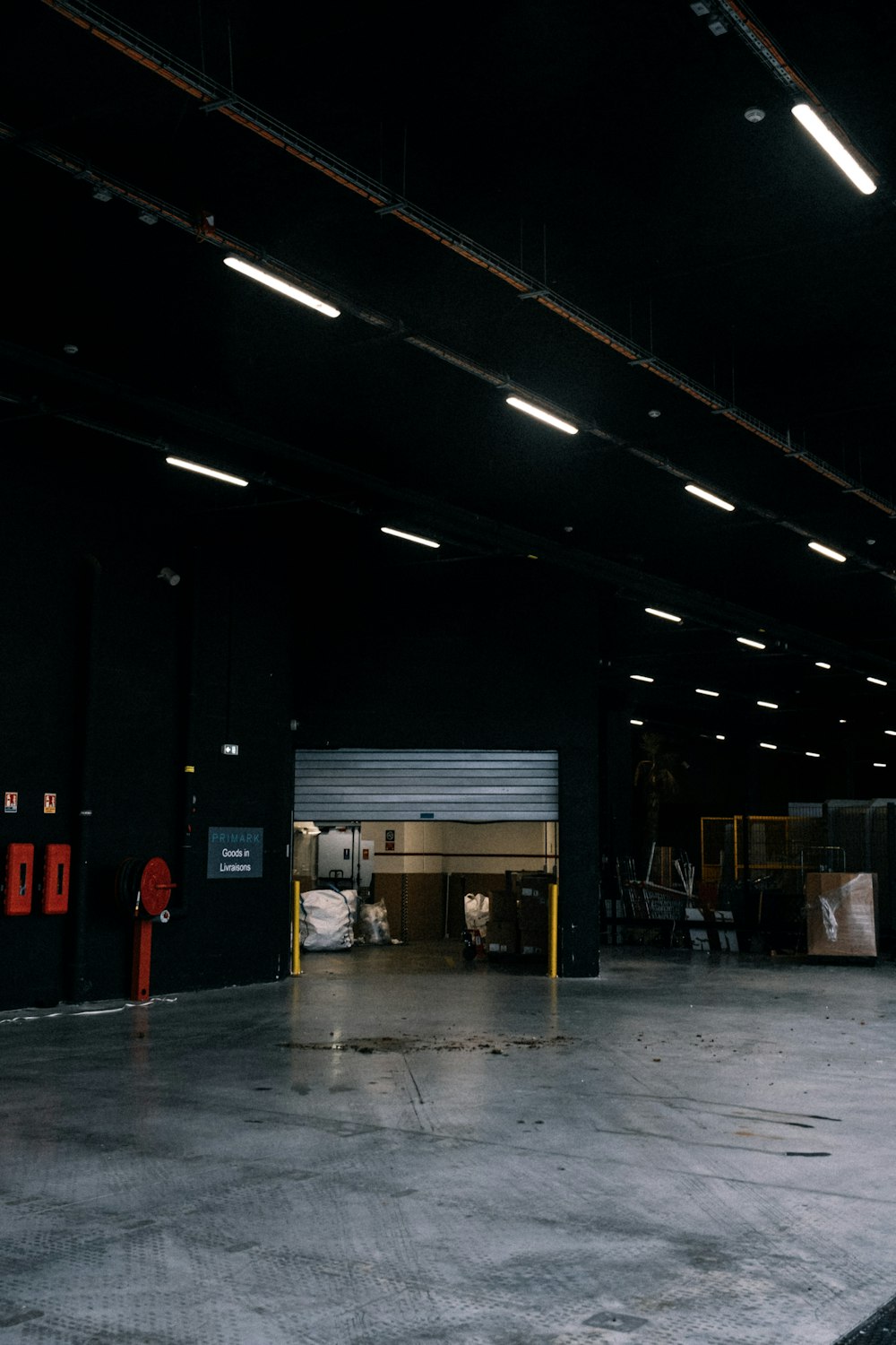 an empty warehouse with a fire hydrant in the middle