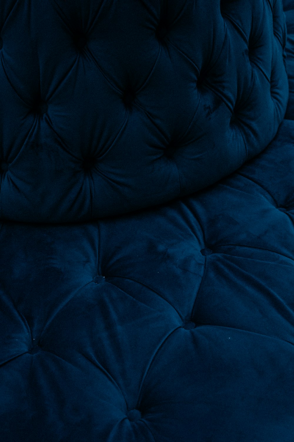 a close up of a bed with a blue comforter