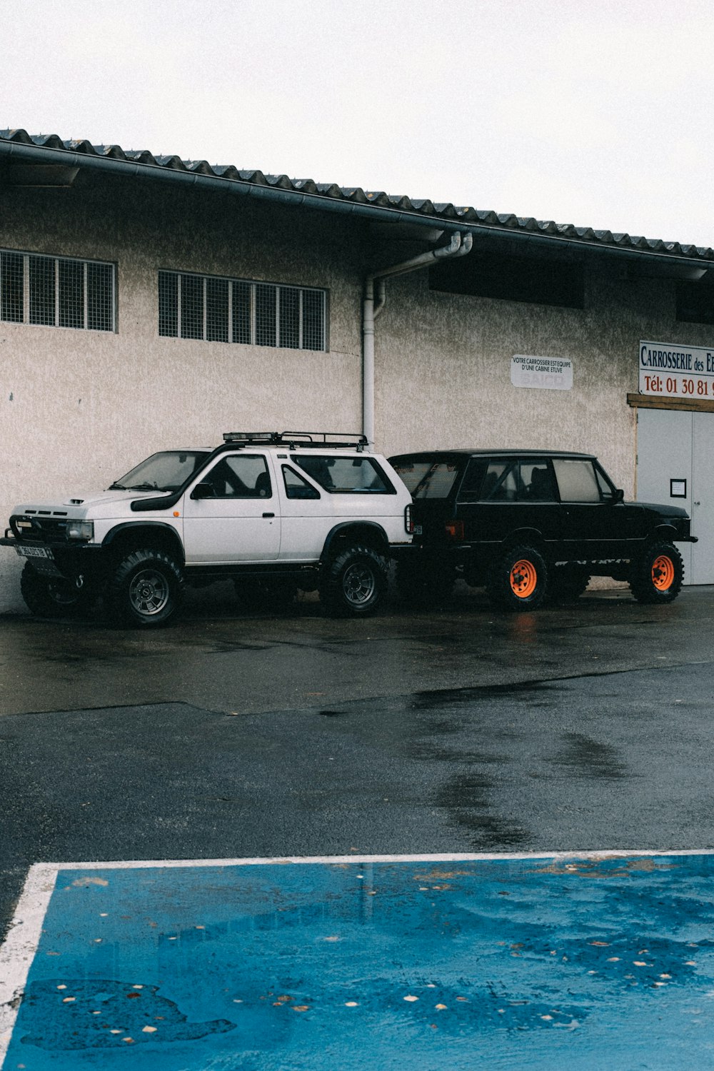 a couple of cars parked in front of a building