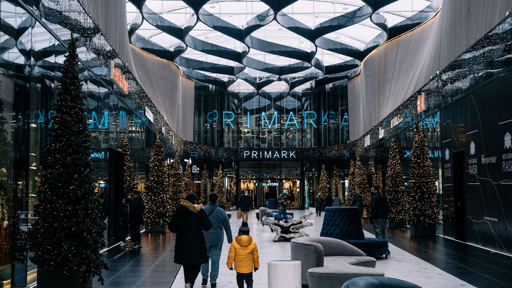 a group of people walking through a mall