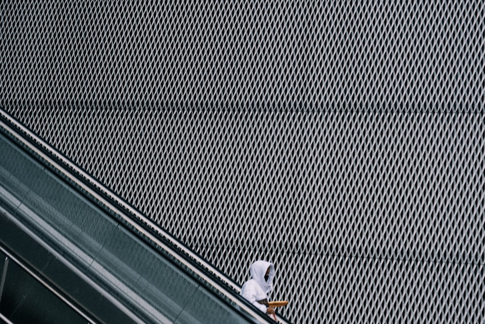 a person riding an escalator on a skateboard