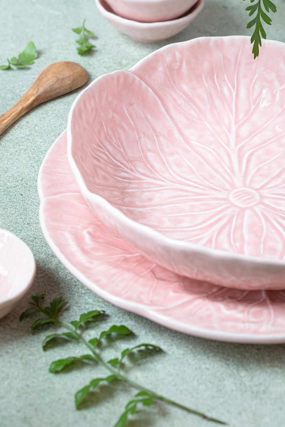 a close up of a pink plate on a table