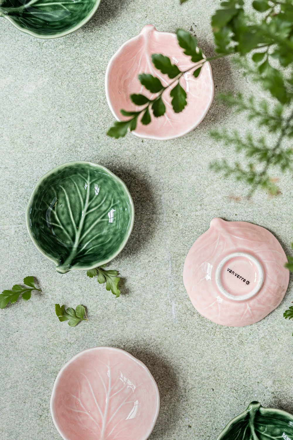 a group of green and pink plates sitting on top of a table