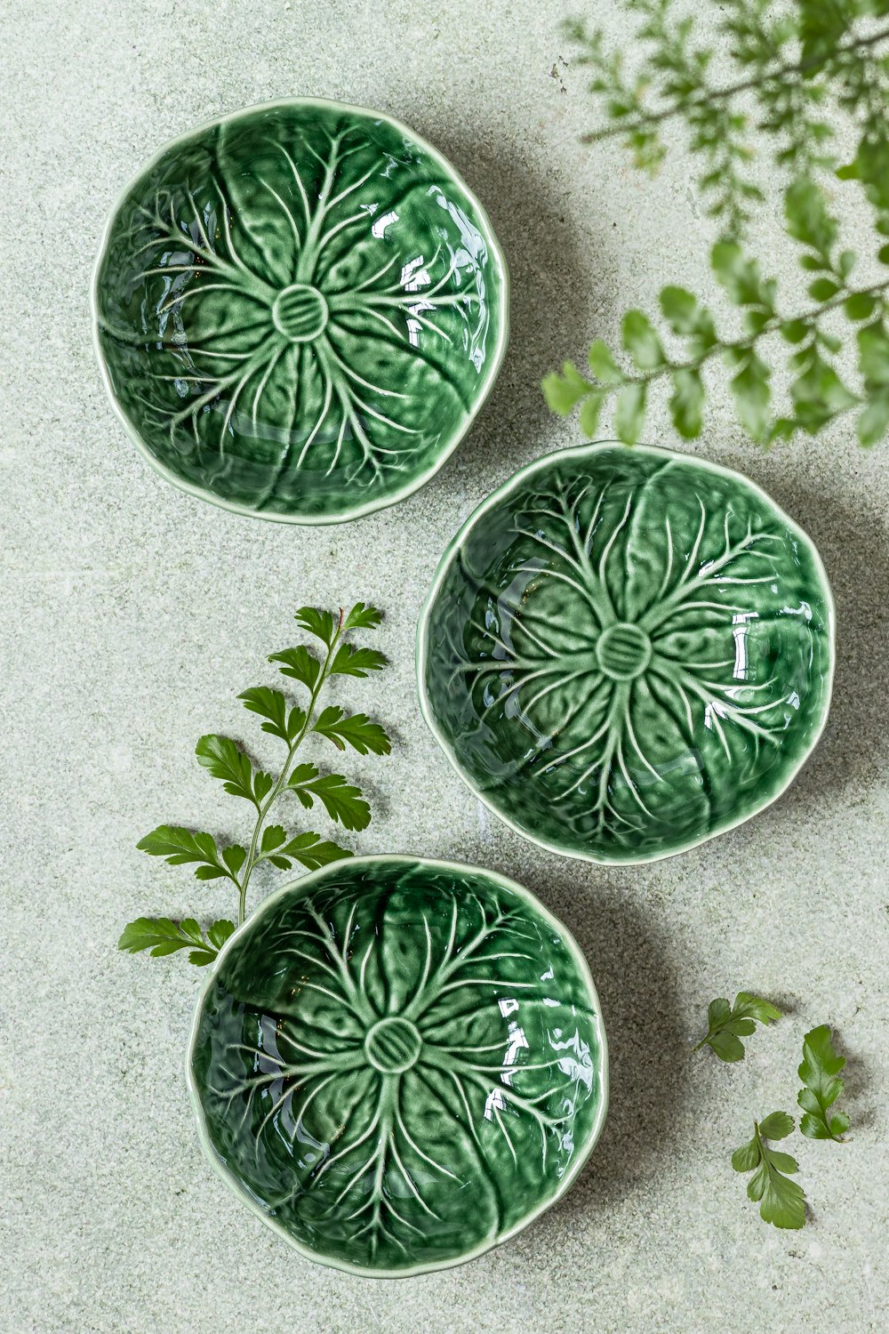 a couple of green bowls sitting on top of a table