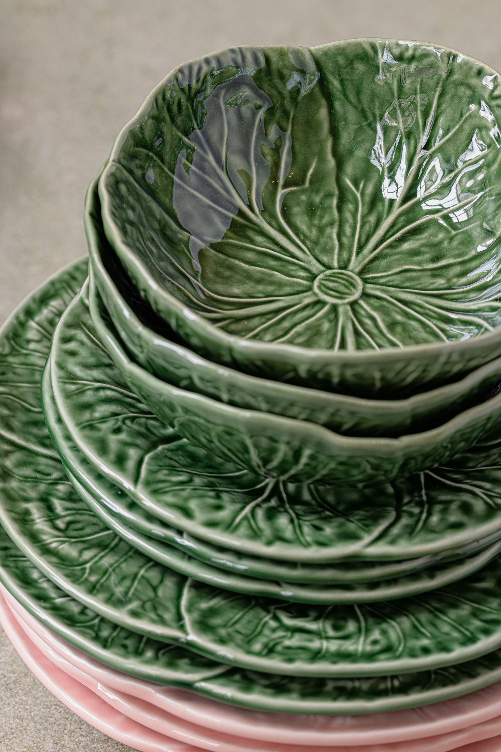 a stack of green and pink plates sitting on top of each other