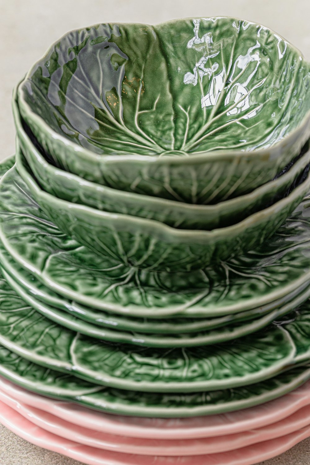 a stack of green and pink plates sitting on top of each other