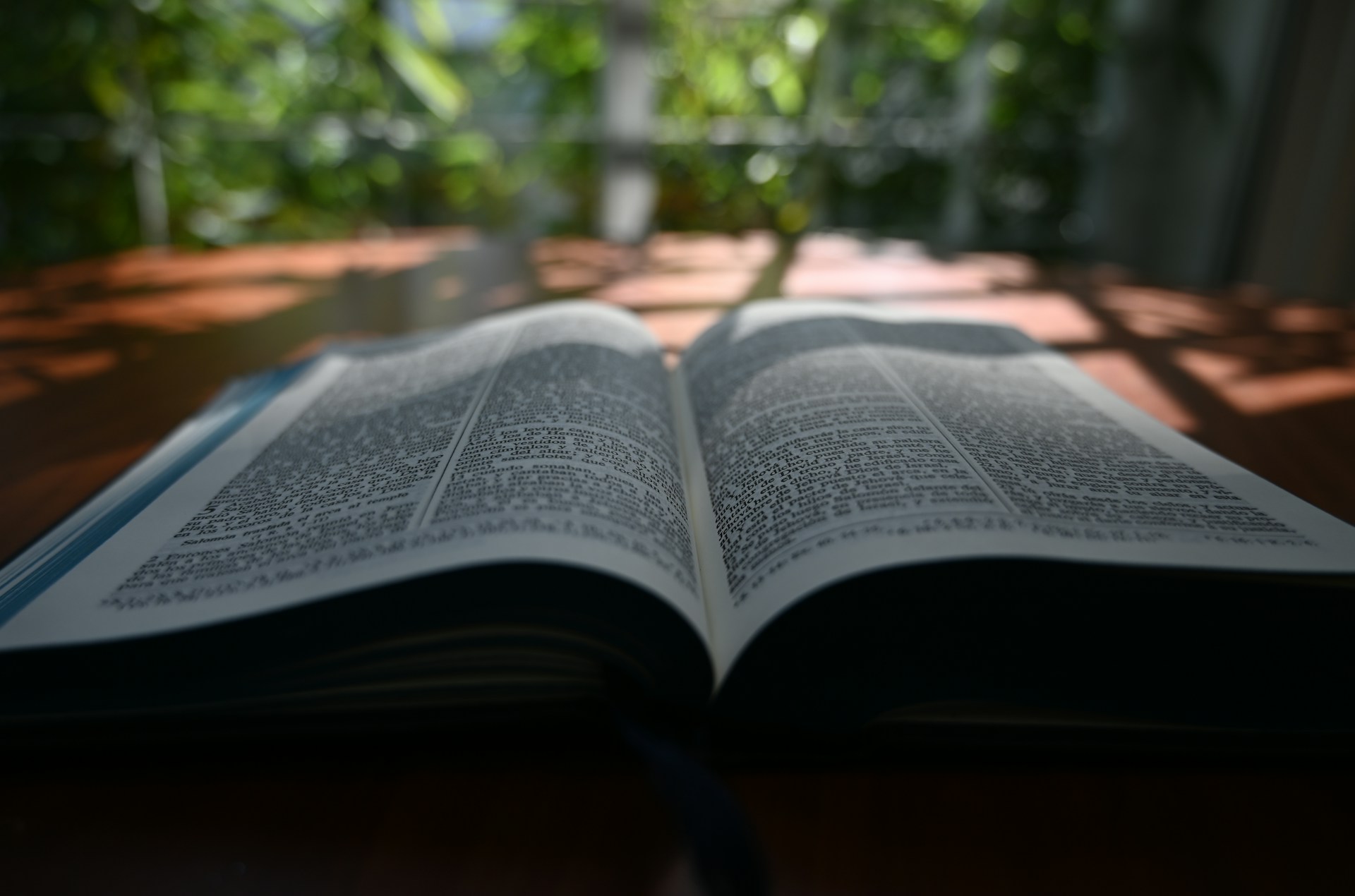 an open book sitting on top of a wooden table