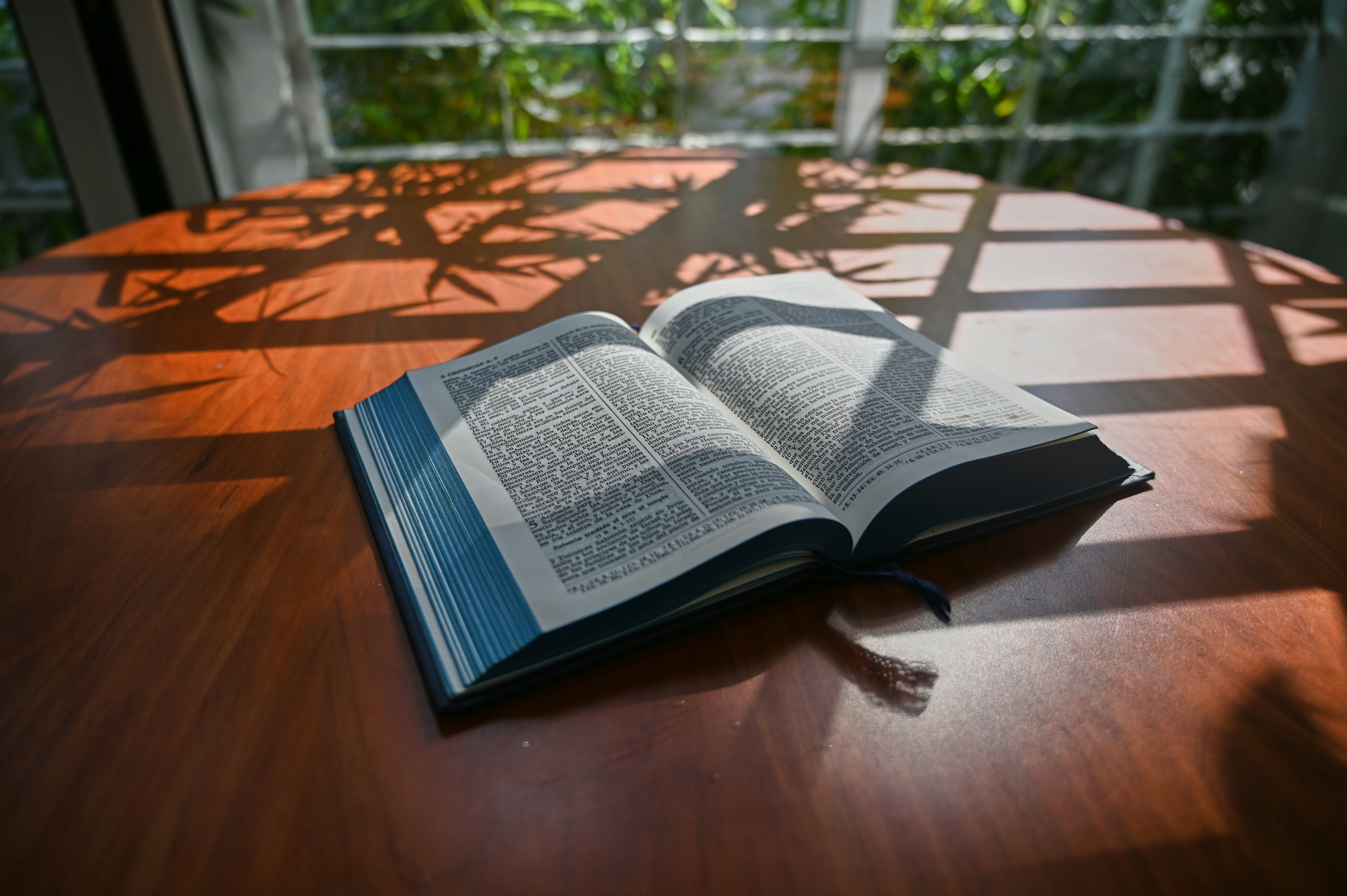 an open book sitting on top of a wooden table