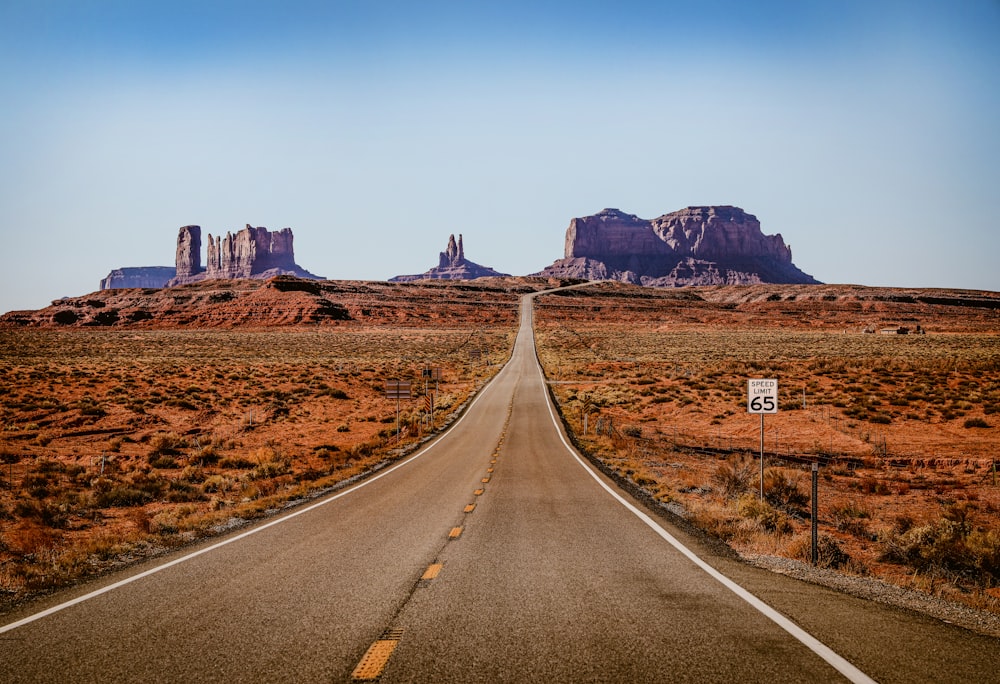 an empty road in the middle of the desert