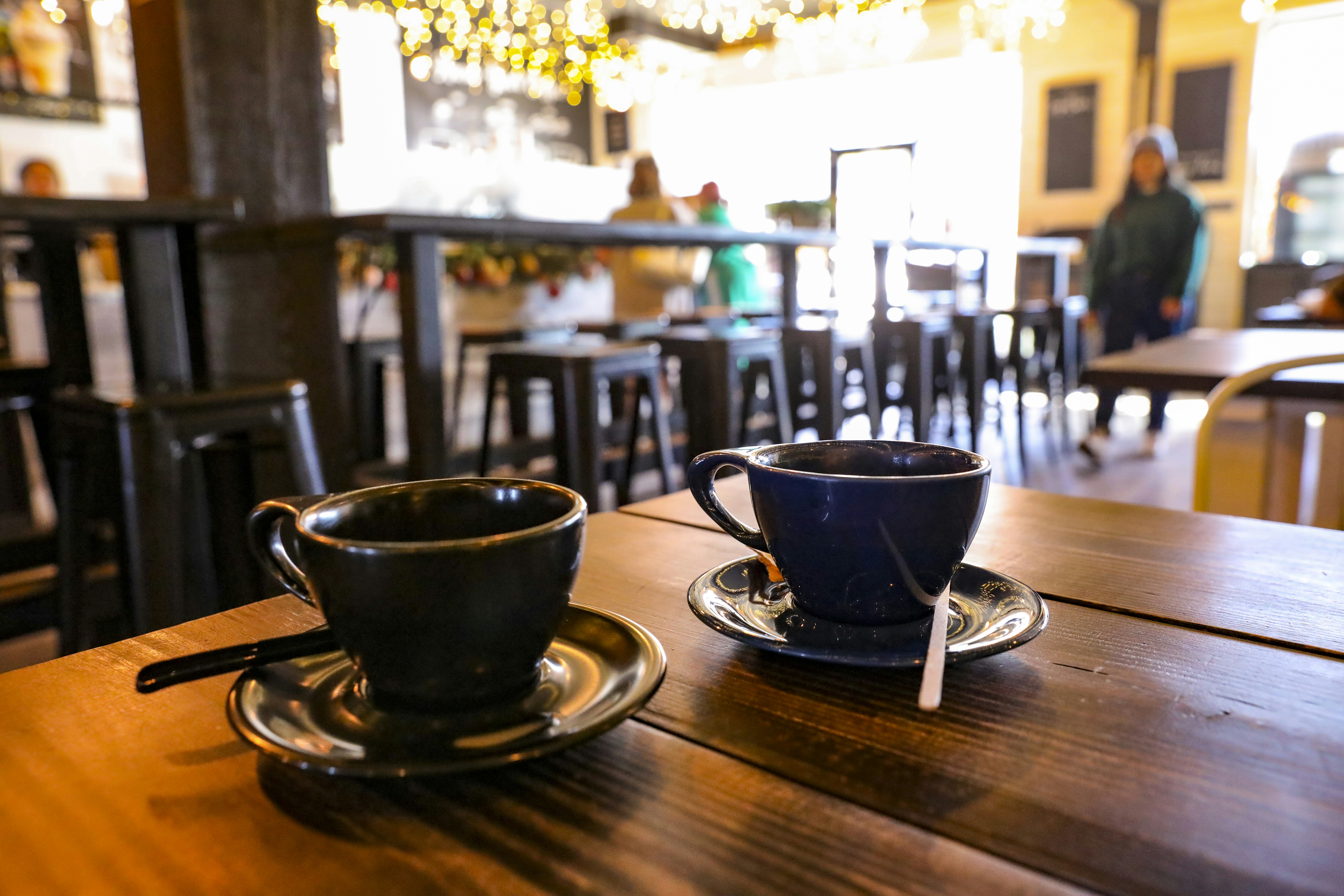 a cup of coffee sitting on top of a wooden table, Coffee shop mood.