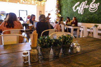 a wooden table topped with pots filled with plants