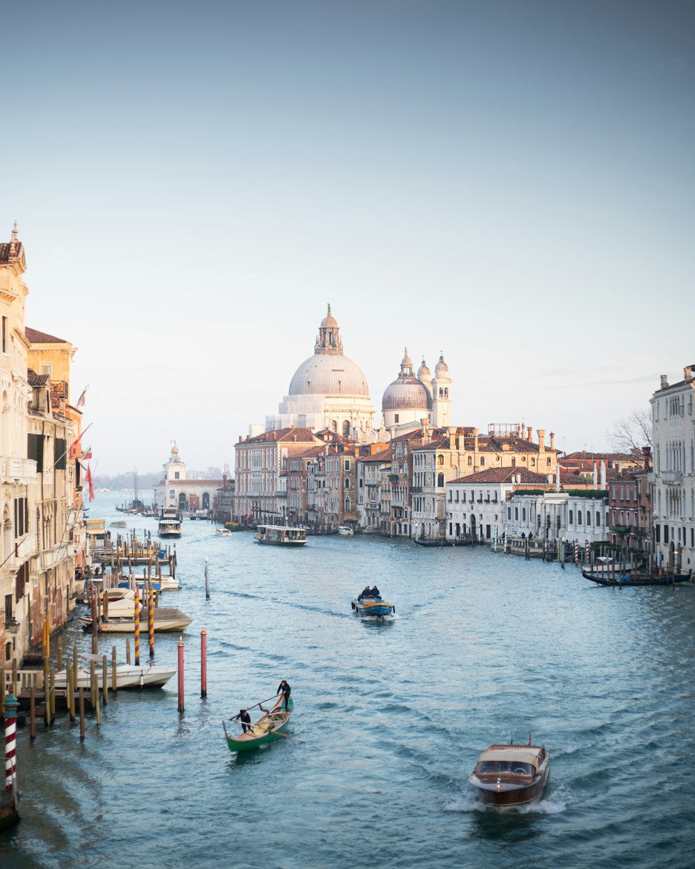 a waterway with boats and buildings in the background